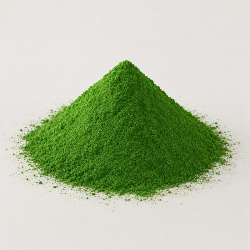 Small mound of concentrated green raw coloring powder for mixing into a tablet binder